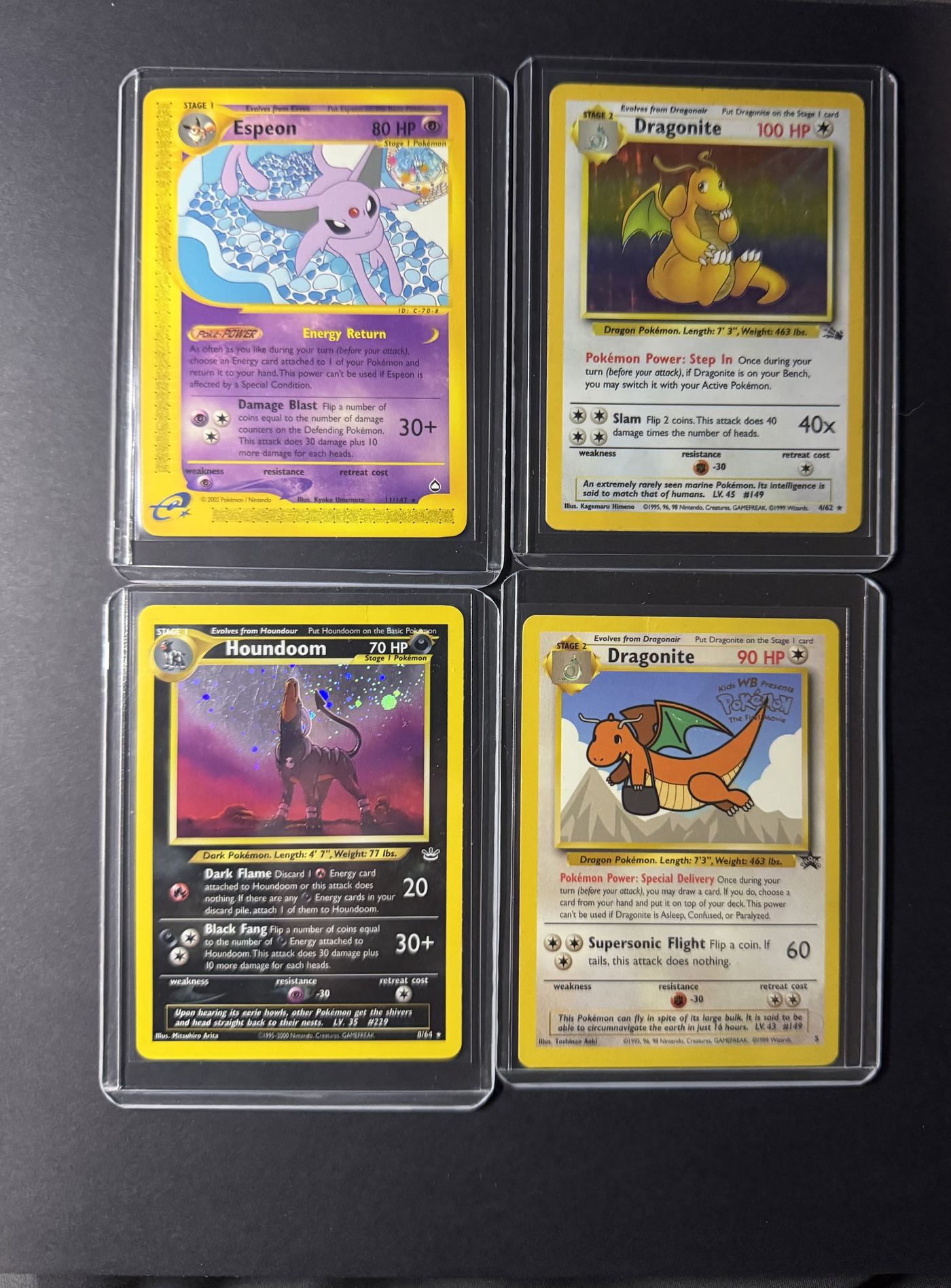 Four vintage graded trading cards, including Espeon and Dragonite, from Rarewake's inventory